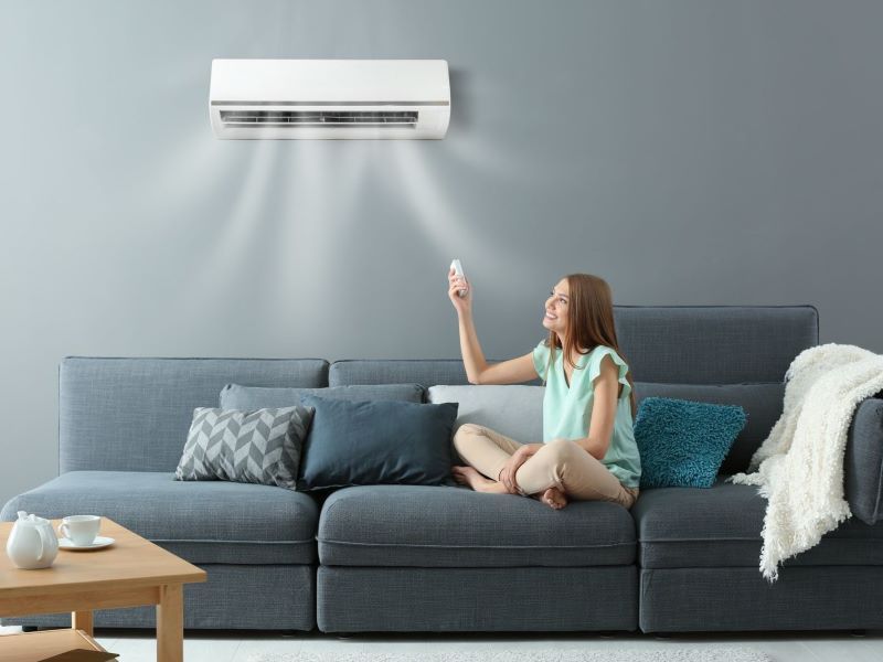 Split System Air Conditioner installed on lounge room wall being controller by a remote
