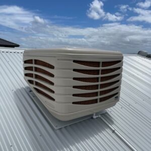 Beige Evaporative Cooler Installed On A Tin Roof