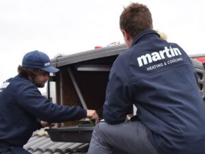 Evaporative Cooling Technicians Repairing Air Conditioning Unit