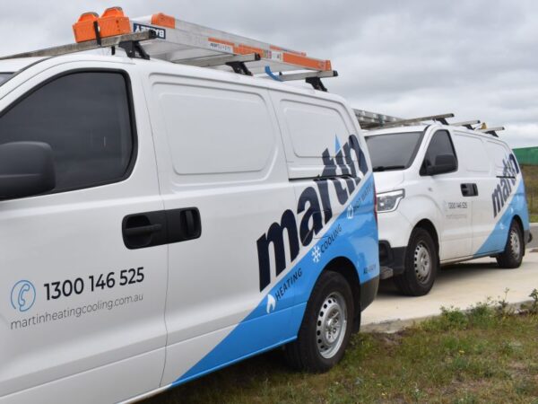 Vans With Martin Heating Cooling Company Logo